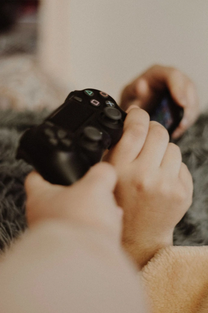 person holding black sony ps 4 controller